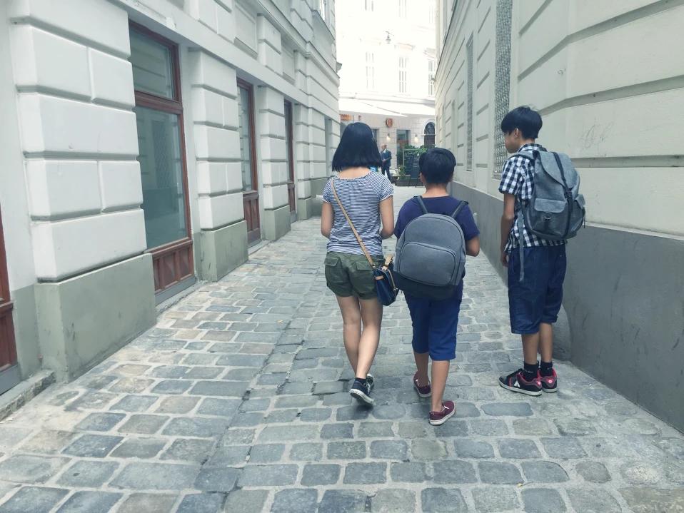 Kids alking on cobblestones Vienna summer